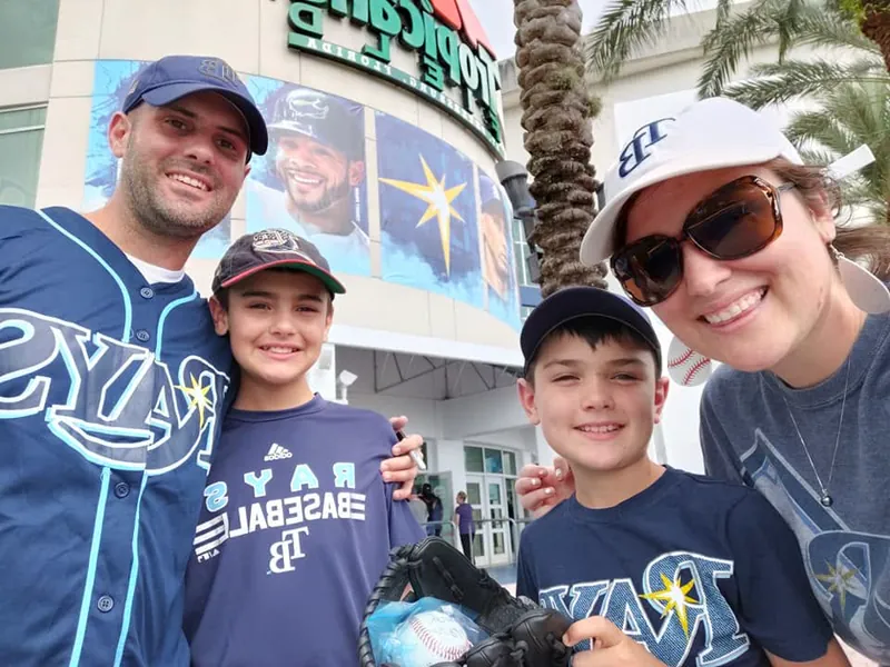 Jerrett, his wife, and their sons together at a Tampa Bay Rays baseball game