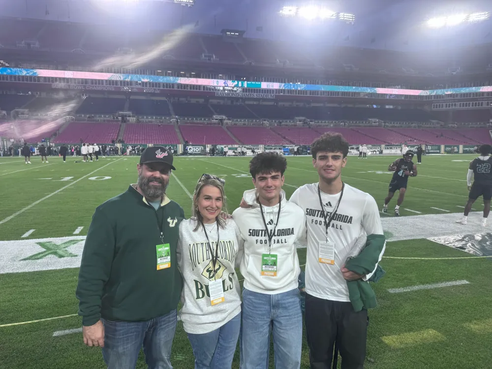 Jerrett and his family together on the football field at Raymond James Stadium