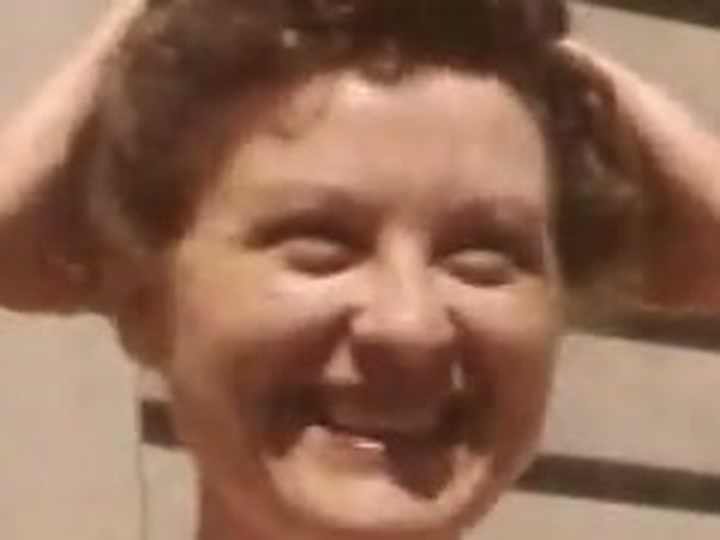 Original 1952 footage — zoomed on a face, visibly soft and grainy